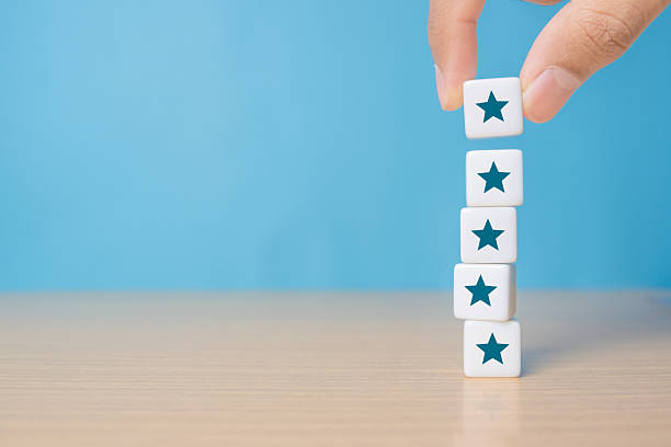 istock Hand put dice stacking with the five star symbol on the table, evaluation, Increase rating, Customer experience, satisfaction and best excellent services rating concept 2248295666