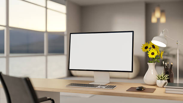 istock White screen computer with books and sunflower vase on wooden table aside wall window in office room 2248296355
