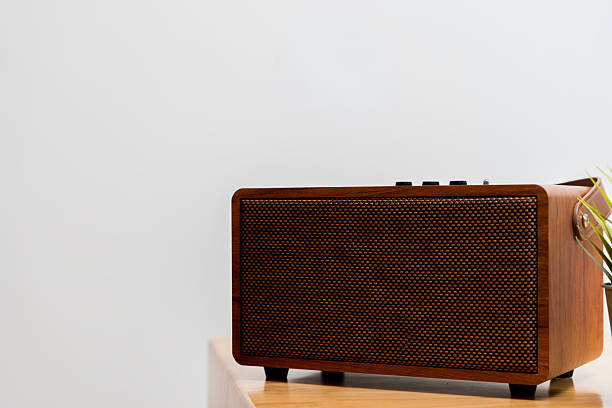 istock Vintage wooden Bluetooth speaker on minimalist table with retro design and warm aesthetic home decor 2248299657