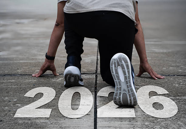 istock Runner at starting position with bold 2026 text on track symbolizing future goals, motivation and progress 2248299676
