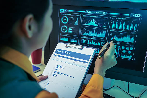istock An Asian businesswoman analyzes digital charts on a computer screen, reviewing performance reports and financial data to develop strategic business insights and support decision-making in a modern 2248300602