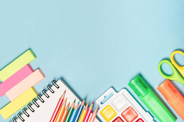 istock Back to school concept mockup. Colorful school stationery, notebook with iron spring, paints and pencils on blue background. 2248301564