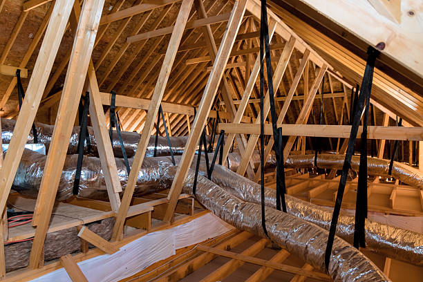 istock Inspecting ductwork roof trusses in an attic during home renovation project 2248303178