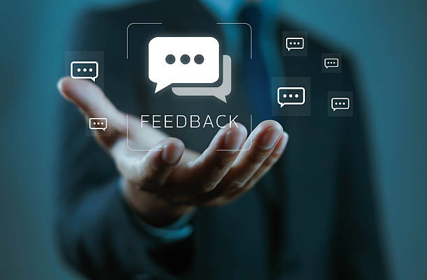 istock Businessman holding digital feedback icon with chat bubbles, symbolizing customer review, communication, survey, online response, business evaluation, client opinion, and service improvement concept. 2248304252