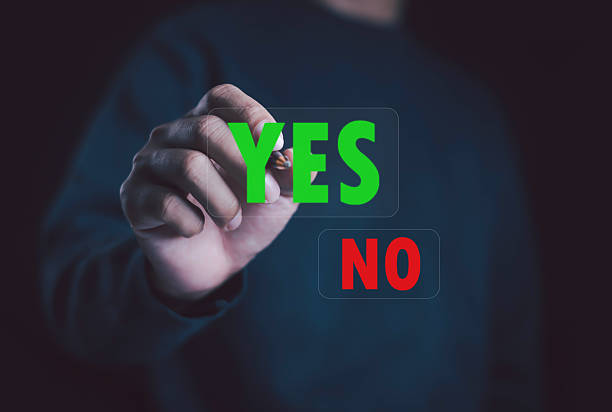 istock Businessman selecting green YES and red NO on virtual touchscreen. Concept for decision making, voting, approval, and business choice in digital interface or online communication design. 2248304268