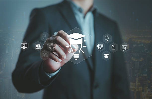 istock Businessman touching virtual education icons with graduation cap and light bulb, symbolizing online learning, digital knowledge, innovation, e-learning technology, future education development concept 2248304466