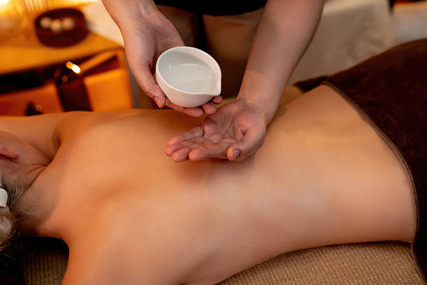 istock Masseuse prepare oil massage procedure for customer at spa. Quiescent 2248308820
