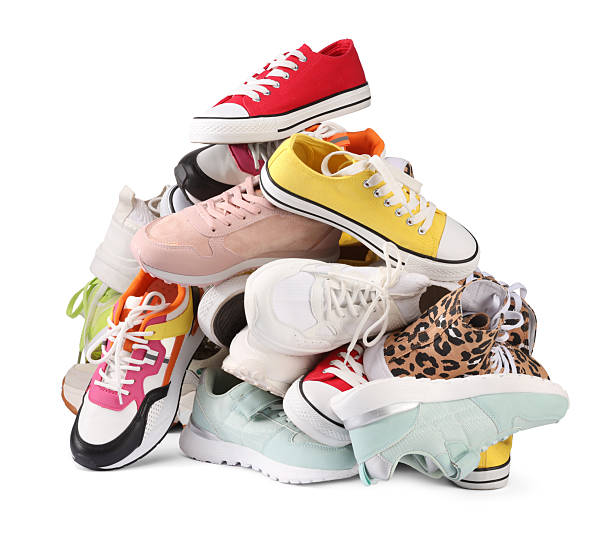 istock Pile of different female sneakers isolated on white 2248309321