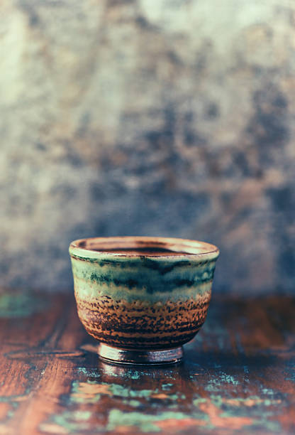 Traditional, handcrafted ceramic on wooden background. Soft focus. Close up.