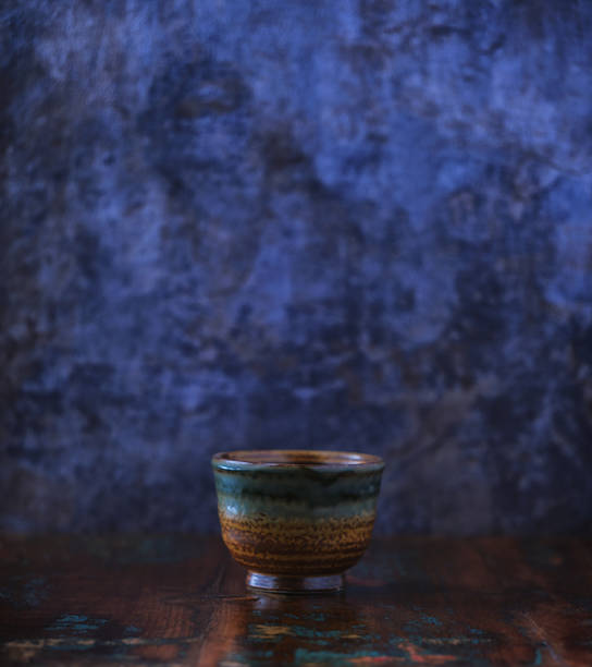 Traditional, handcrafted ceramic on wooden background. Soft focus. Close up.