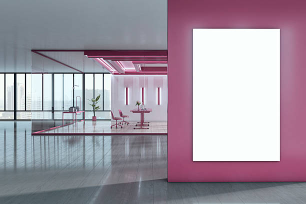 istock Vertical blank poster mockup on pink wall in modern office interior with glass partitions, overlooking cityscape through large windows. 3D Rendering 2248312032