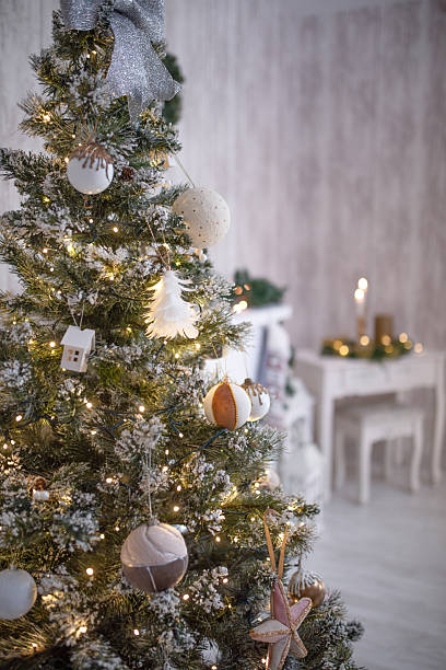 istock Christmas tree adorned with festive ornaments, twinkling lights, and a silver bow, creating a warm and inviting holiday atmosphere in a cozy interior setting 2248313770