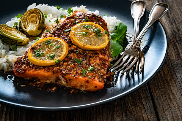 istock Baked salmon with white rice on wooden table 2248314111