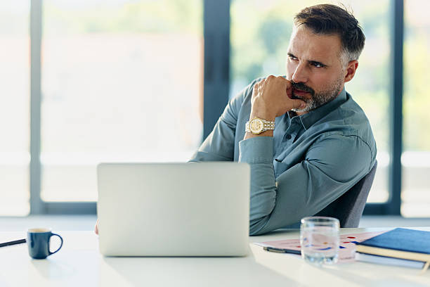 istock Thoughtful businessman working on laptop in the office. 2248317272