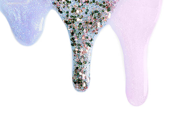 istock Different color nail polishes flowing on white background 2248317752
