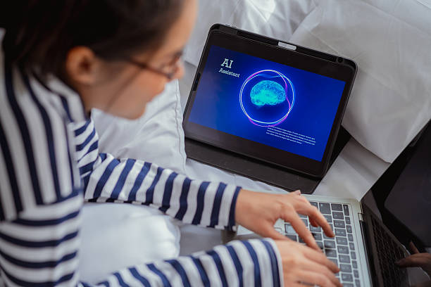 istock Professional woman laydown on bed utilizing AI powered assistant on smartphone and tablet laptop for automated workflow optimization, leveraging cutting-edge machine learning technology for business productivity working at home freelance analysis and work 2248317931