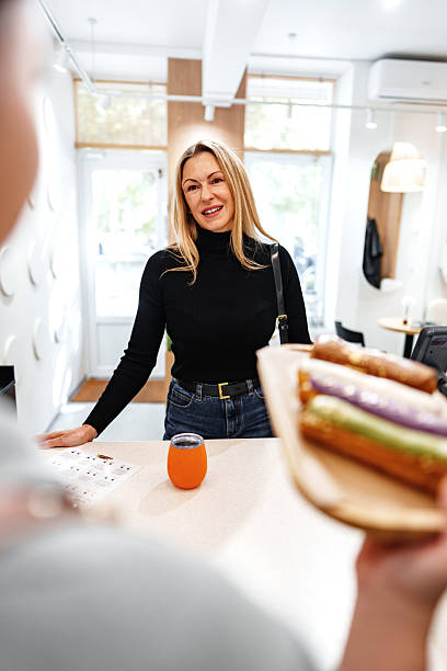 istock Friendly interaction at a cafe with fresh food and drink in a cozy setting 2248318709