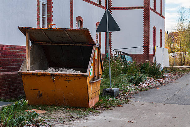 istock Construction waste bin placed beside a quiet street in autumn 2248319344