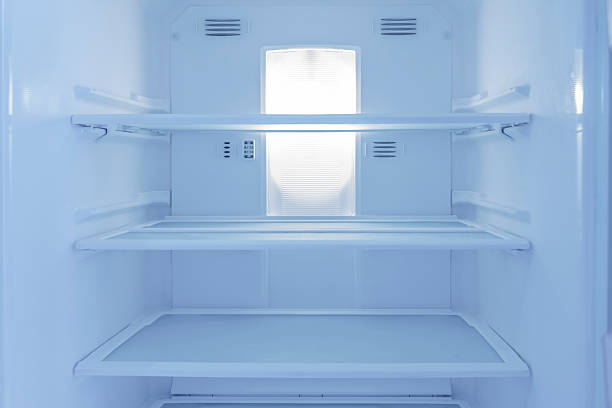 istock View Inside an Empty Refrigerator with Clean Glass Shelves for Home Storage 2248320797