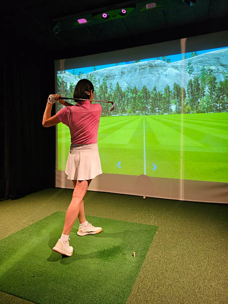 istock Young golfer practicing their swing indoors at a golf simulator with a scenic backdrop on the screen concept 2248320990