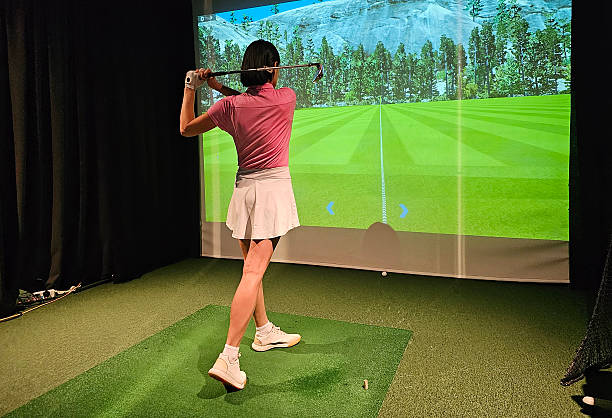 istock Indoor golf practice session featuring a female golfer using a simulator in a woodland 2248320991