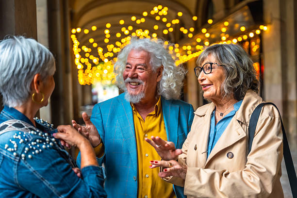 istock Mature adults talking and laughing in archway with lights 2248322522