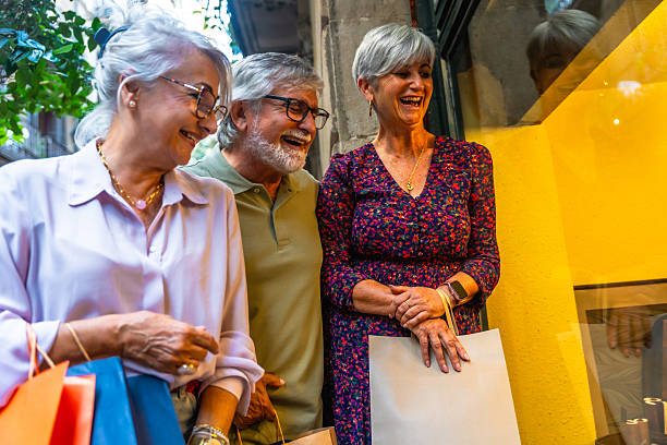 istock Senior friends laughing during window shopping downtown 2248322931