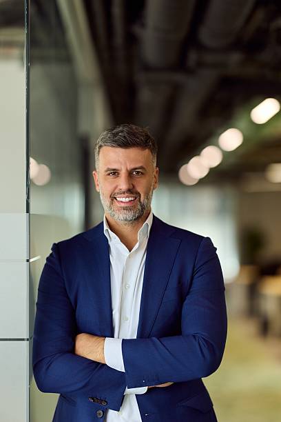 istock Professional Man In Blue Suit Smiling In Modern Office Portrait 2248324732