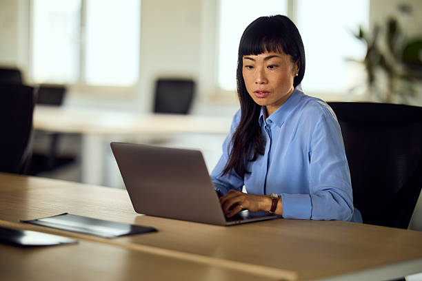 istock Professional Woman Working On Laptop In Modern Office Setting 2248324752