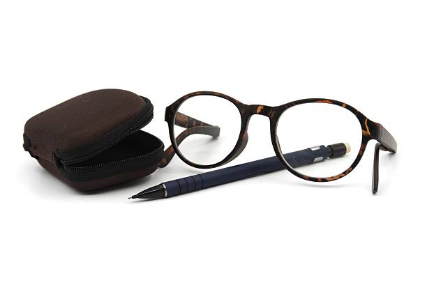 istock Reading glasses with tortoiseshell frames, pen and tack 2248326567