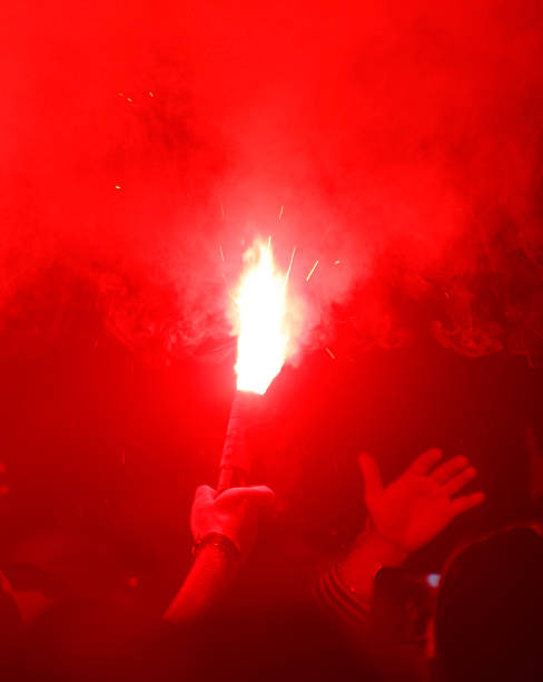 istock A person holding a red torch in a crowd 2248326586