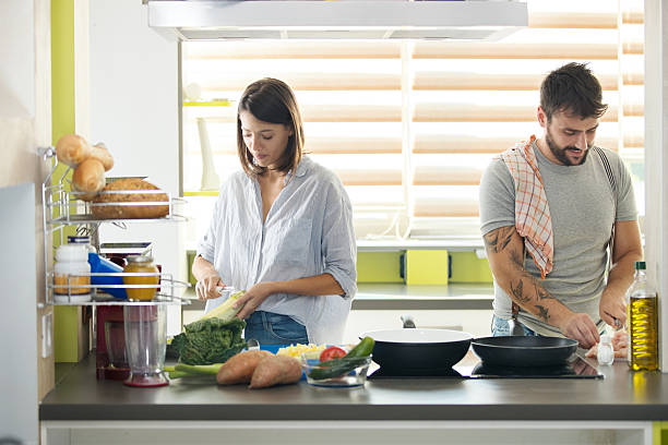 istock Young family cooking lunch at home. 2248327068