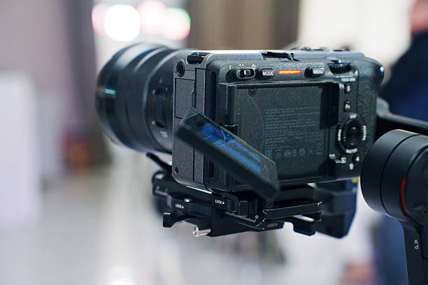 Camera equipment on tripod captures event moment indoors
