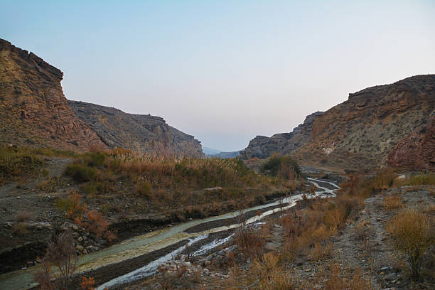A river flows through a canyon. High rocky mountains and a river. Beautiful natural scenery.