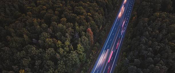 istock Aerial highway view with vehicle light trails at dusk. 2248329247