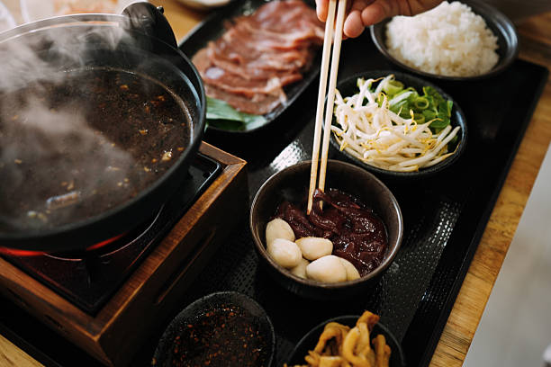 istock Thai-Japanese Fusion: Boat Noodle Nabe Hot Pot - Tabletop Cooking Scene 2248329533