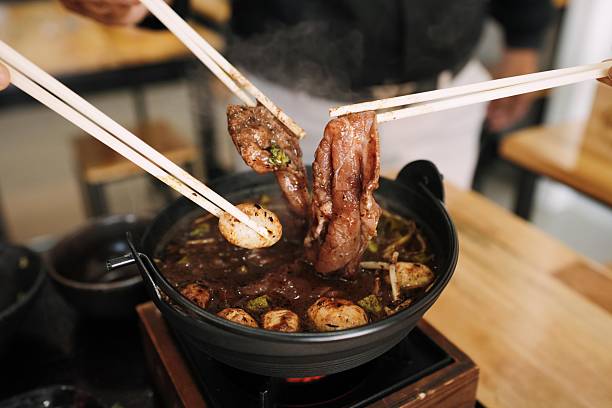 istock Thai-Japanese Fusion: Boat Noodle Nabe Hot Pot - Tabletop Cooking Scene 2248330085