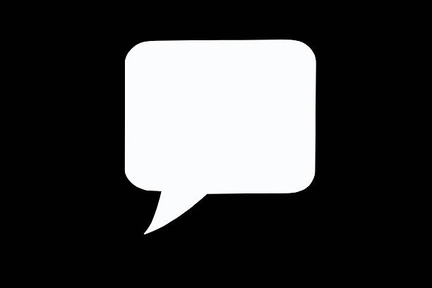 Paper speech bubble in the shape of a rectangle on a black background. Flat white chat icon in the form of an empty speech bubble. Free space for text or image. Internet communication concept