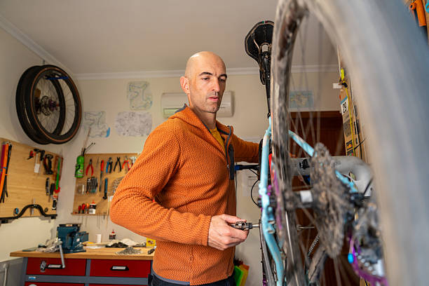 istock Adult man repairing bicycle in home workshop 2248338449