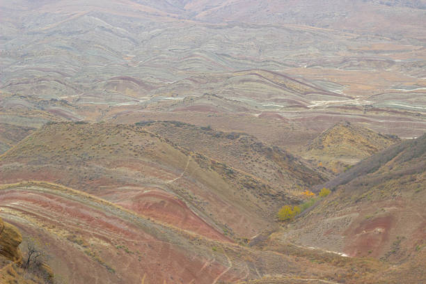 Photographed on 15 November near the David Gareji road in eastern Georgia, the image captures expansive mountain ridges with distinctive geological striping. The muted autumn tones and vast open terrain highlight the dramatic character of this remote landscape.