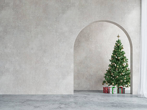 istock A modern minimalist living room with an elegantly decorated Christmas tree placed under an elegant arched niche, an empty cement textured wall and copy space, on brushed concrete floor 2248339199