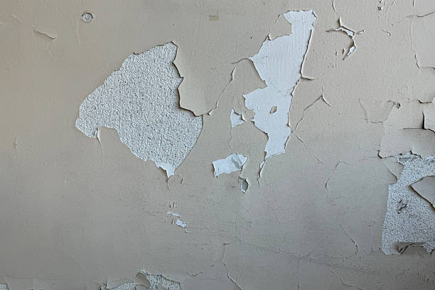 istock Old cement wall with cracked peeling paint. Abstract background and texture for interior and exterior decoration design and industrial construction concept. Old paint that look like countries and continents on a world map. 2248341188