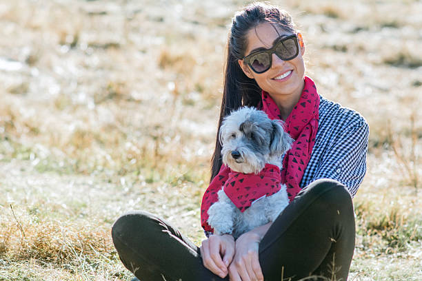 Woman hugging her havanese dog outdoor