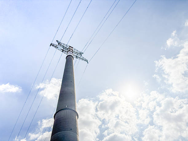 High voltage towers at blue sky background. Power lines against the sky
