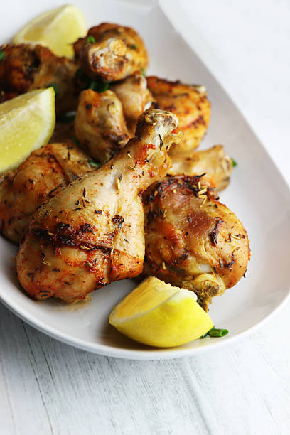 istock Roasted chicken drumsticks legs on white plate 2248343865