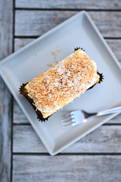 Sweet mille-feuille pastry with creamy filling and crispy topping on a plate