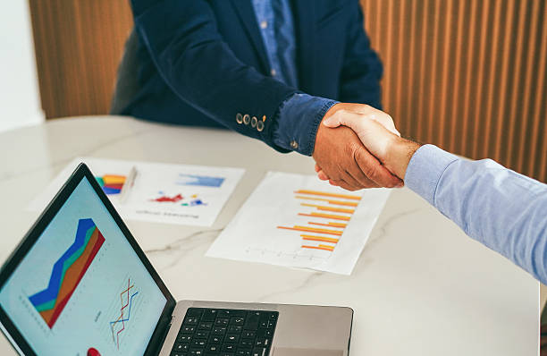 istock Business people working inside modern office - Colleagues shaking hands while greeting on a new work project - Deals and job meeting concept - Main focus on hands 2248344583