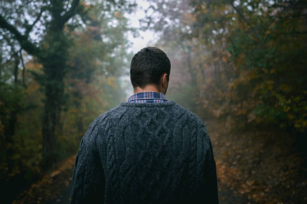 istock Man walking on foggy autumn forest path 2248345733