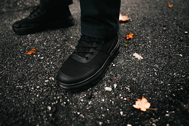 istock Person walking on asphalt path during autumn season 2248346688