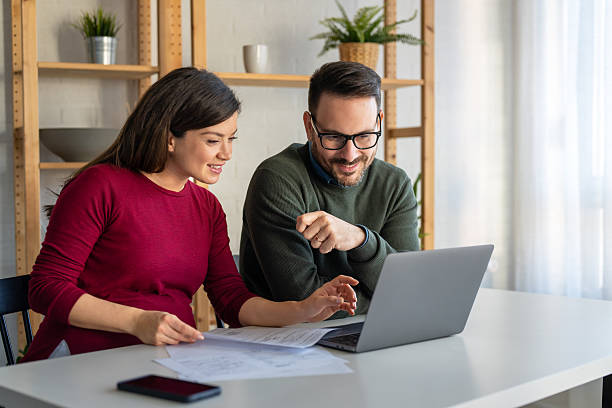 istock Happy businesspeople laughing while collaborating on a new project in an office. 2248347561